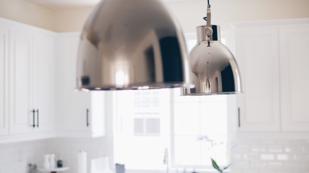 Pendant lights hanging above a kitchen island at working height